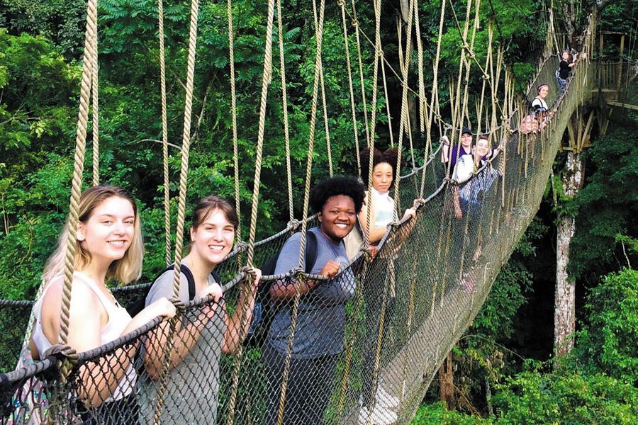 Students in Ghana on a rope bridge